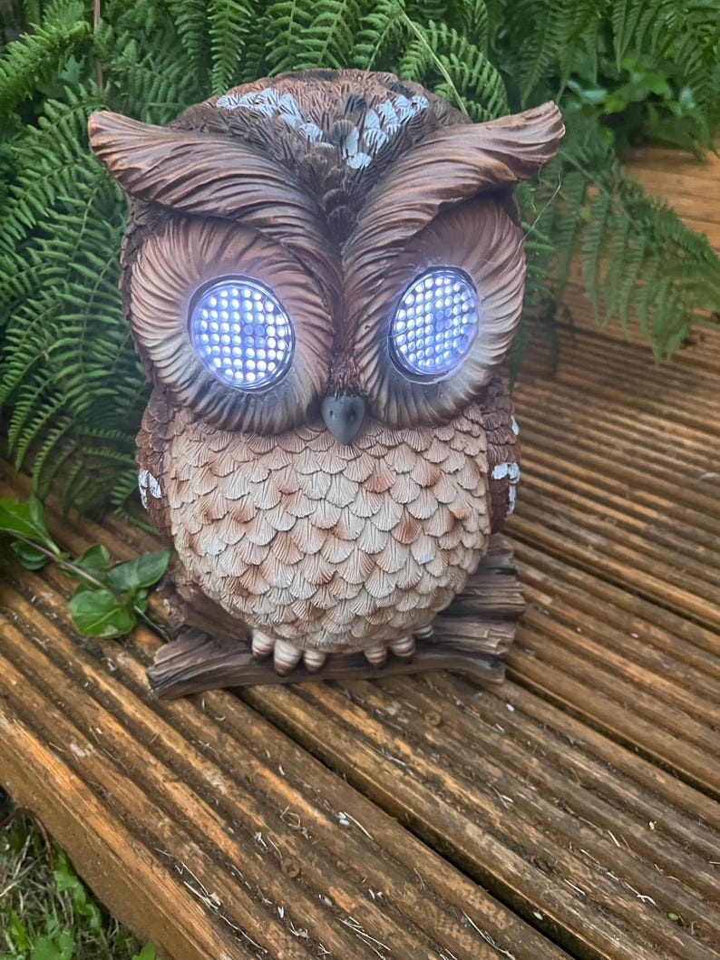 Solar-powered owl winking illuminated sculpture