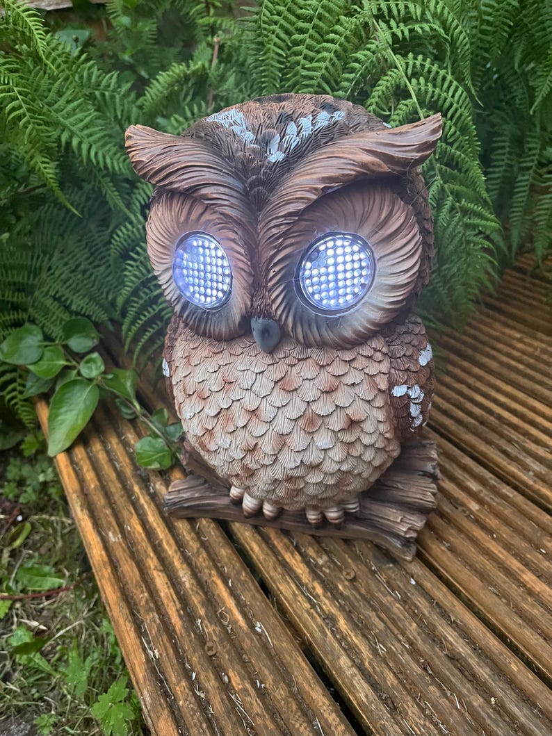 Solar-powered owl winking illuminated sculpture