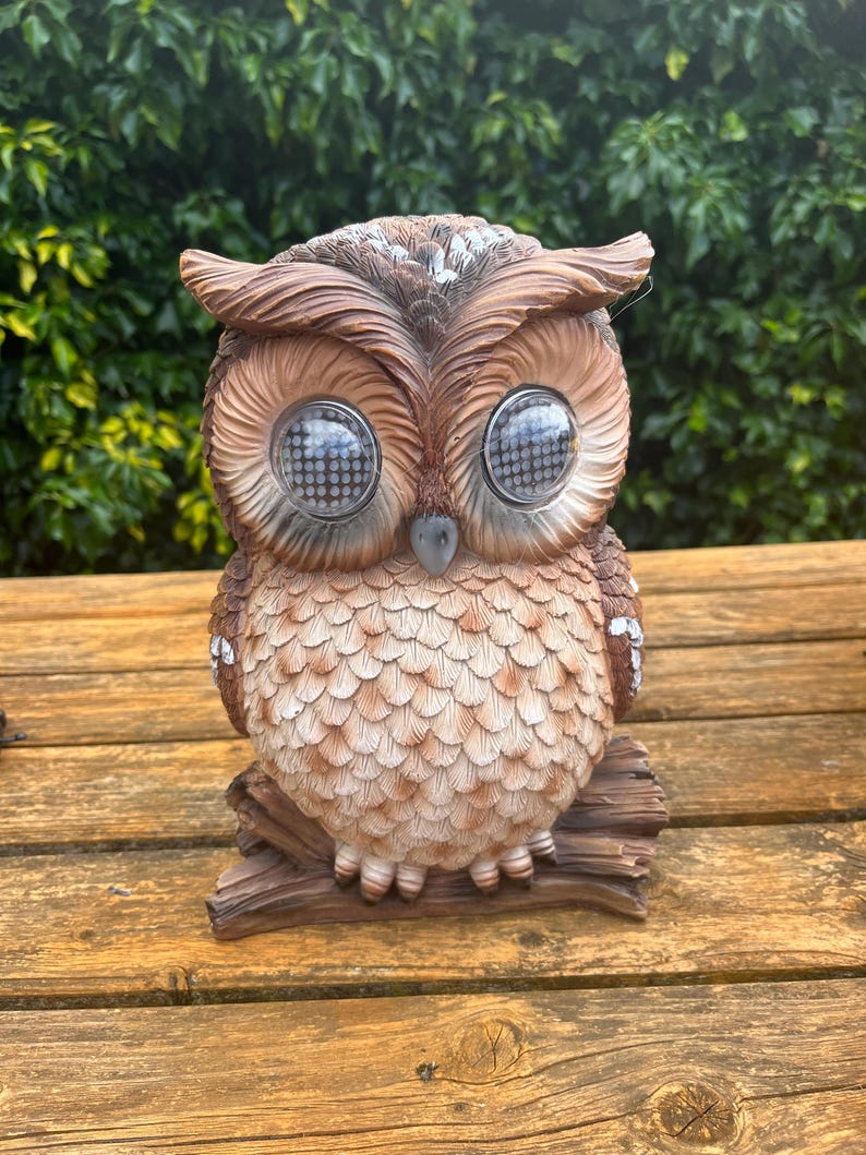 Solar-powered owl winking illuminated sculpture